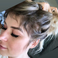 Close-up of a woman's scalp and hair showing new hair growth and healthy strands, illustrating HairLove customer results.