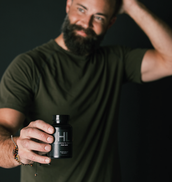 A happy Man holding Black bottle of HAIRLOVE hair growth complex for men, daily hair vitamin