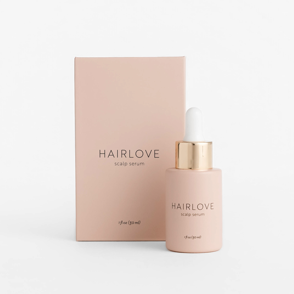 Front view of HAIRLOVE Scalp Serum 1 fl oz dropper bottle and box showing blush-pink bottle with gold cap on white background