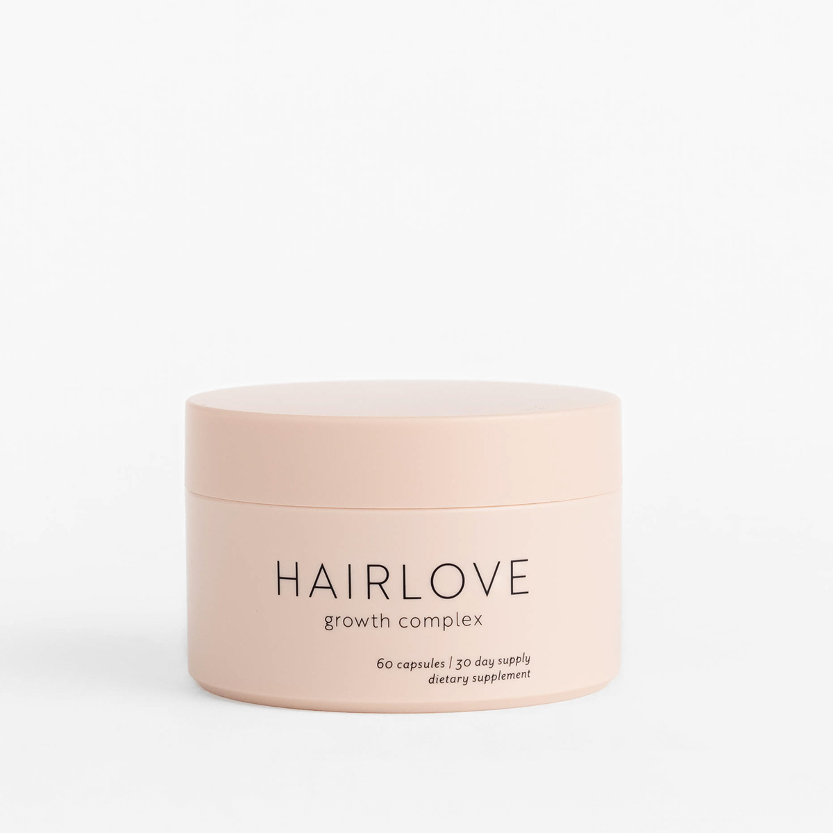 Front view of Growth Complex Storage Jar showcasing pale blush finish and HAIRLOVE label with white background